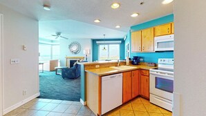 A modern kitchen with wooden cabinets, a white stove, and a built-in dishwasher.