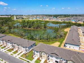 A residential area with houses, a road, and a body of water.