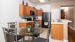 Enjoy cooking in this well-equipped kitchen with a dining table and microwave, coffee maker, and refrigerator.