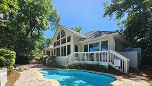 A house with a swimming pool, a covered deck, and a white fence. - Pet Friendly Golf Course Home w/ Private Pool (Hilton Head Island)