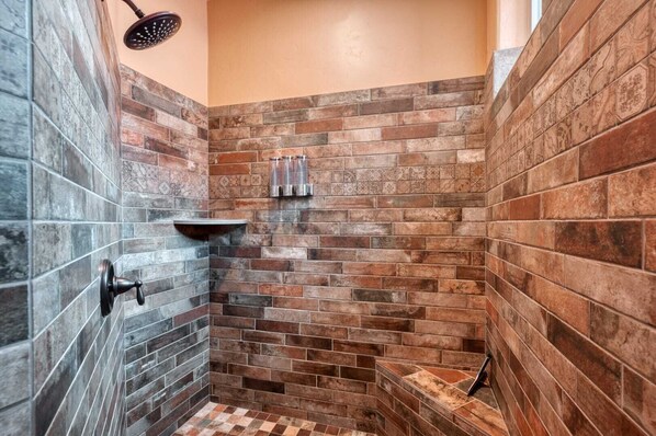 Bathtub, hair dryer, towels, shampoo