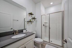 Bathtub, hair dryer, towels, shampoo