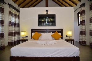 Relax in a spacious room with a large bed, two nightstands, and a framed artwork above.