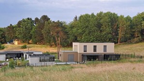 A modern building with a flat roof, a garage, and a covered outdoor area. - Luxurious villa close to Colmar, Kaysersberg... (Labaroche)