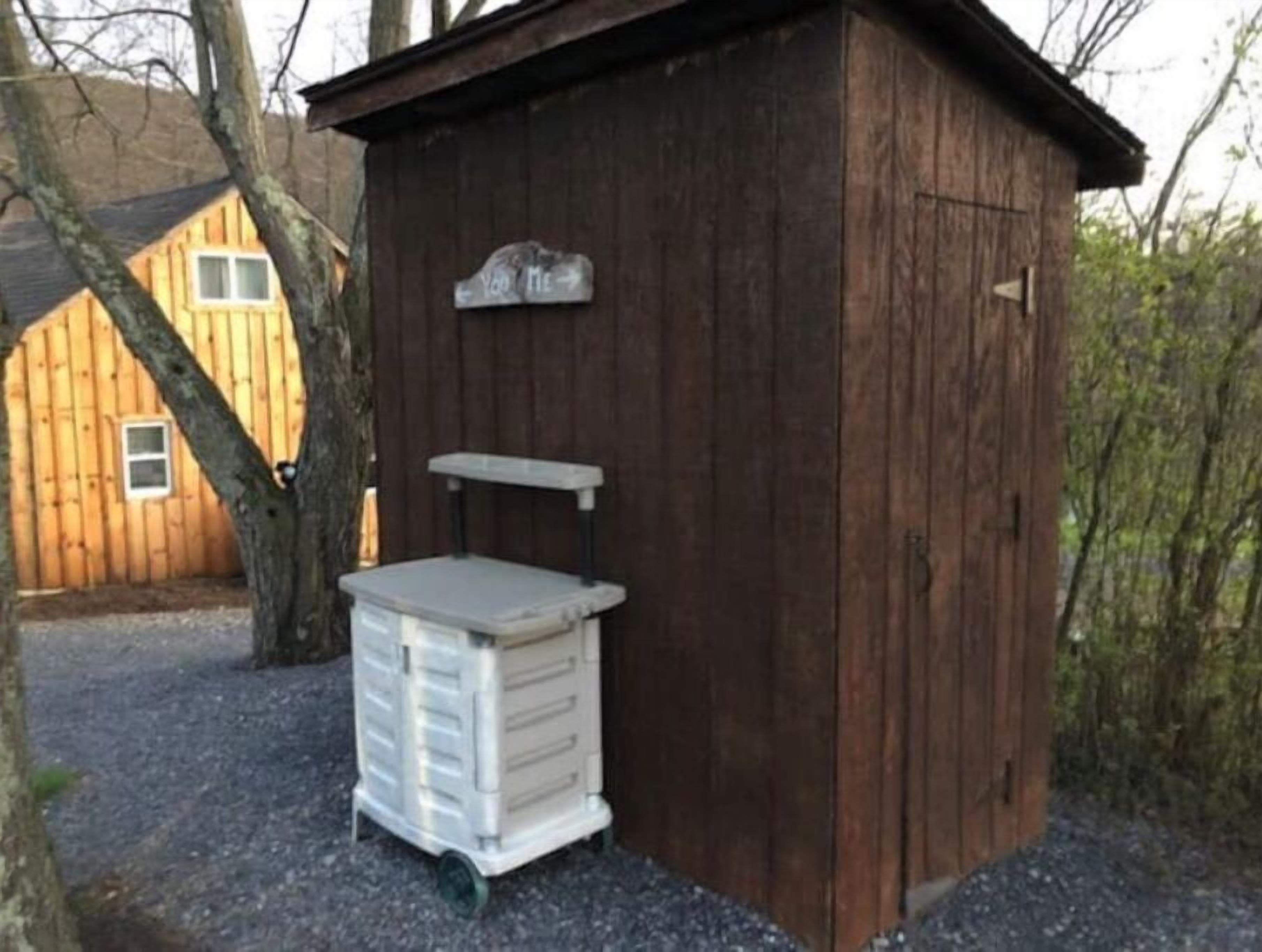 A small wooden shed with a sign that reads "You Tie."