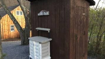 A small wooden shed with a sign that reads "You Tie."