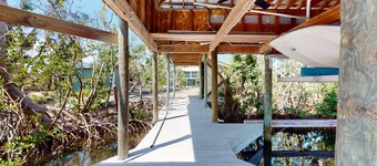 Tropical Palm Island home steps from the beach with grill, outdoor shower, dock