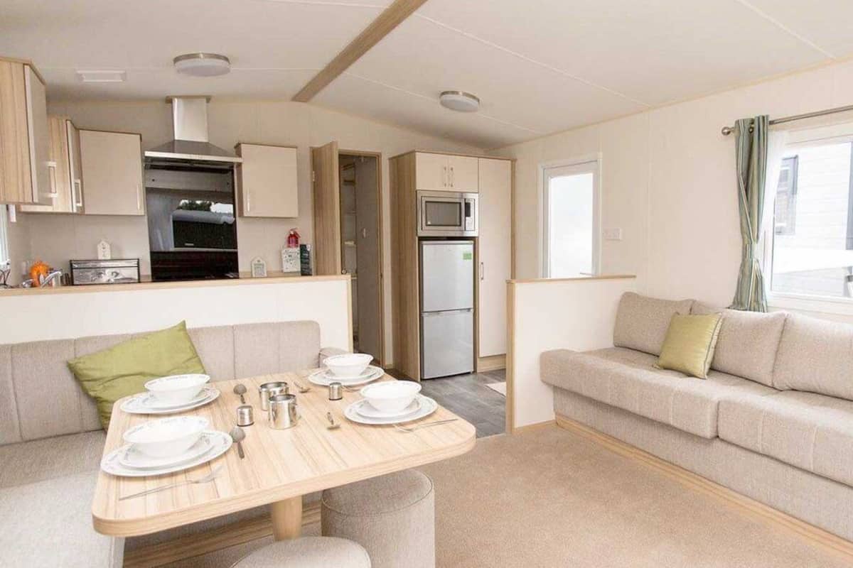 A compact living space with a kitchenette, a dining area, and a sofa.