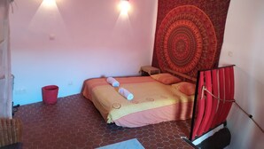 A small, cozy room with a bed, a tapestry, and two wall-mounted lights. - Attractive, Renovated Village House in Traffic-free Street (Estagel)