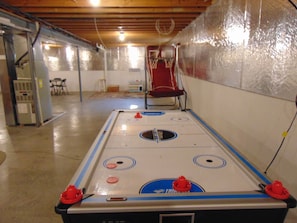 Relax and play in this spacious room with a shuffleboard table at its center.
