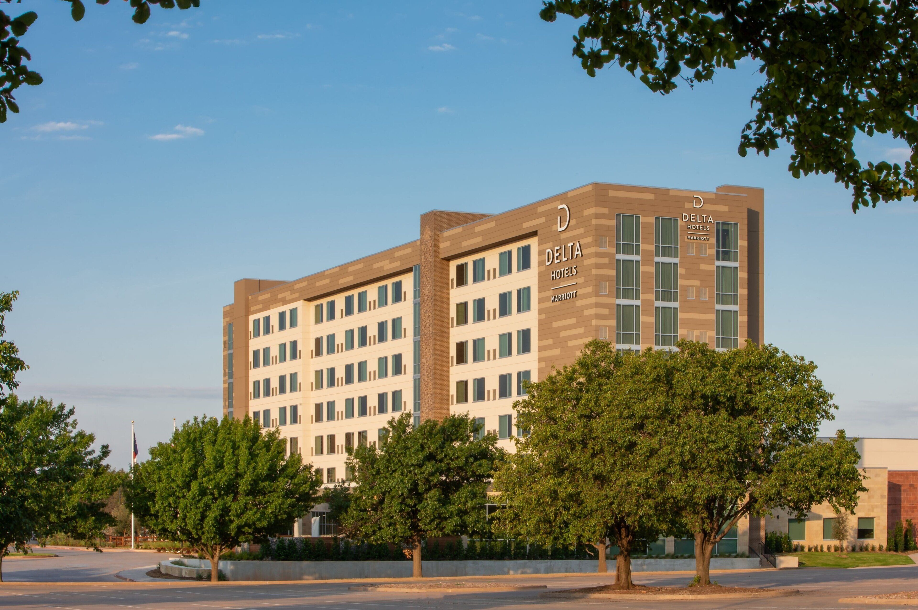 A multi-story building with the sign "Delta Hotels Marriott" on the side.