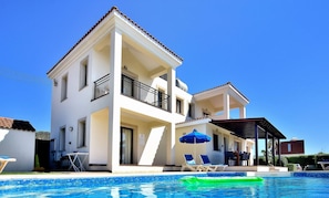 A two-story house with a swimming pool, outdoor furniture, and a covered patio area. - Nature - Direct To Sandy Beach, Impressive Villa, Quiet Area (Argaka)