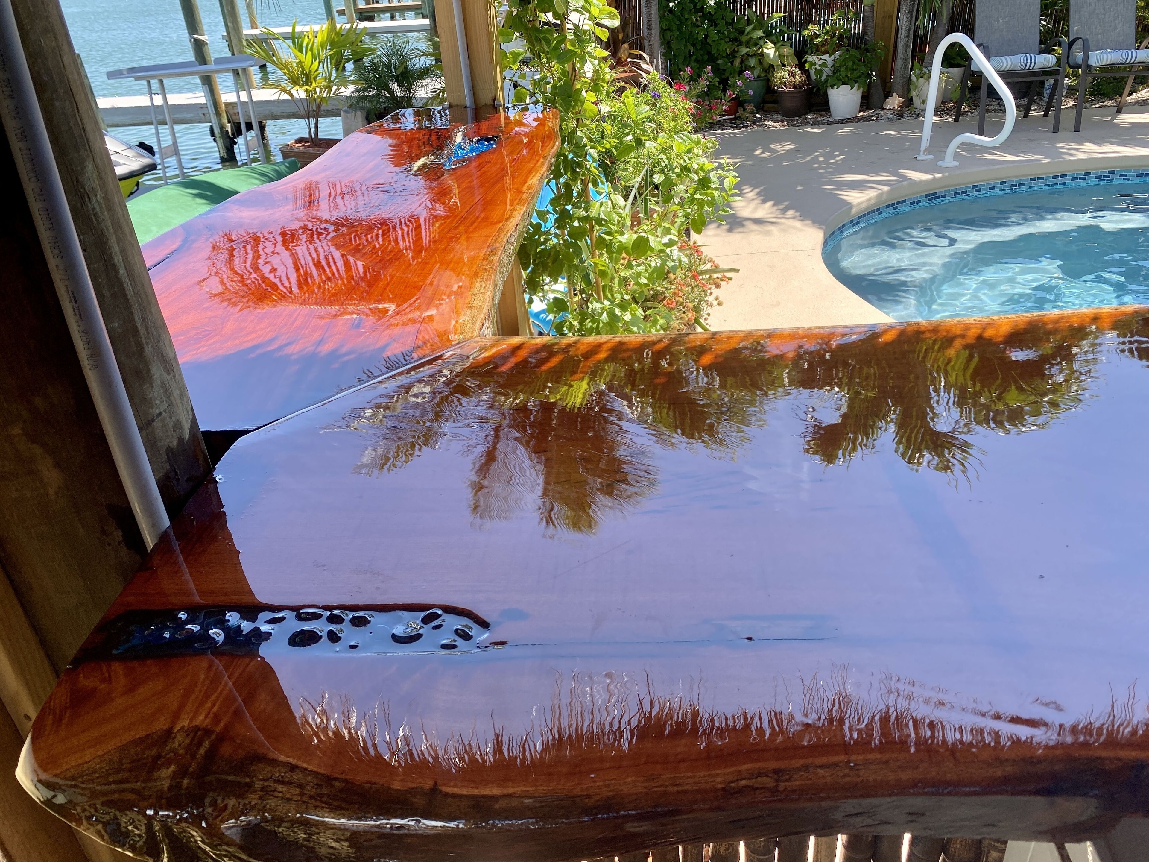 A pool area with a wooden deck and a pool.