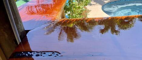A pool area with a wooden deck and a pool.