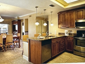 Enjoy cooking in this well-equipped kitchen with a central island, sink, and stainless steel oven.