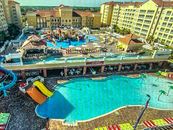 Relax by the resort's central pool, surrounded by walkways and amenities like a water slide.