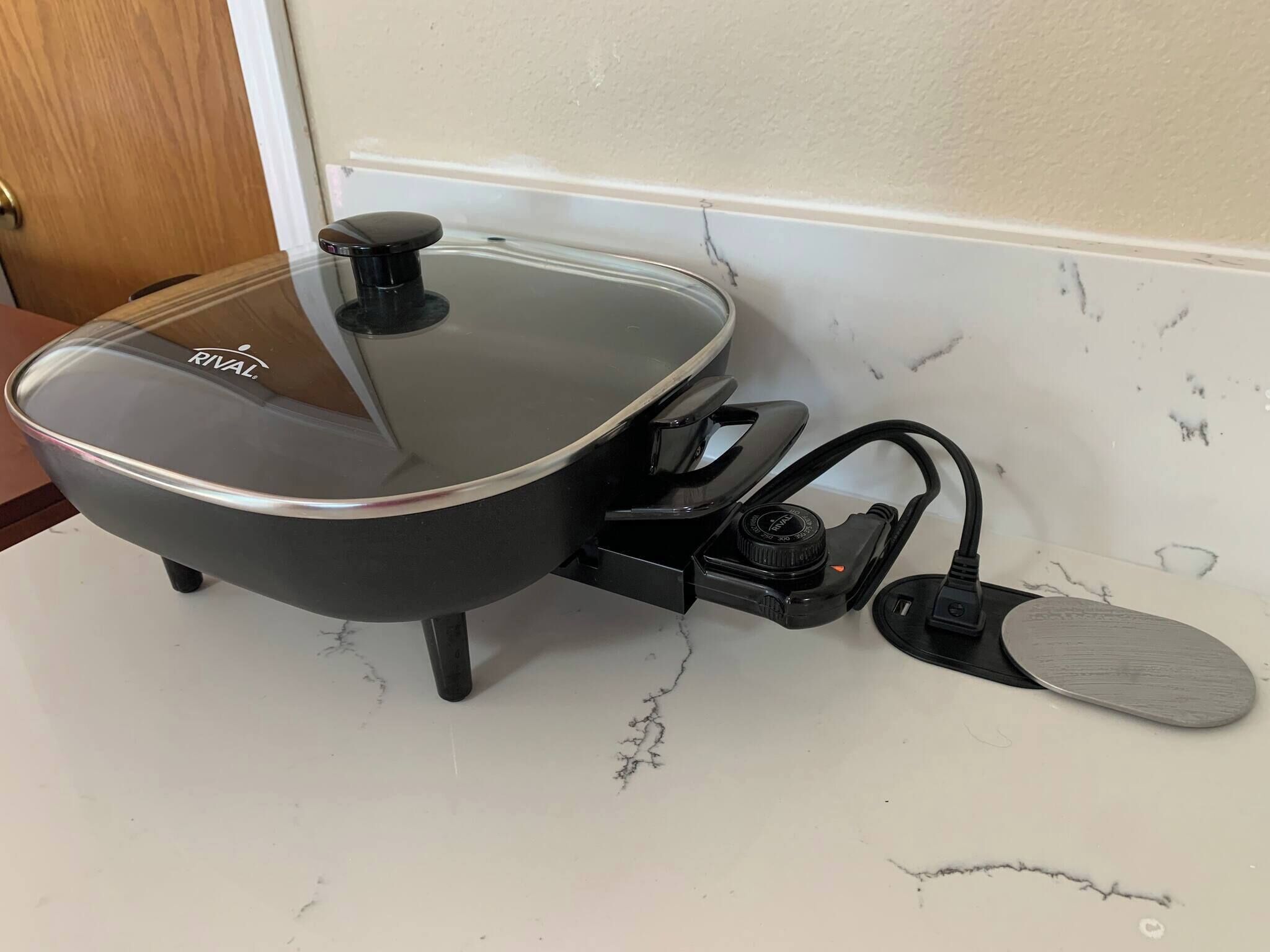 A kitchen with a stove, a sink, and a countertop.