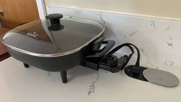 A kitchen with a stove, a sink, and a countertop.