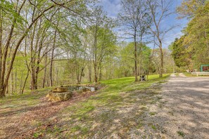 Stroll through the wooded area, surrounded by trees and a serene pond, and enjoy a peaceful moment on one of the benches or picnic tables.