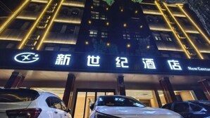L’entrée d’un hôtel, avec une enseigne lumineuse, un espace de stationnement et la façade du bâtiment.