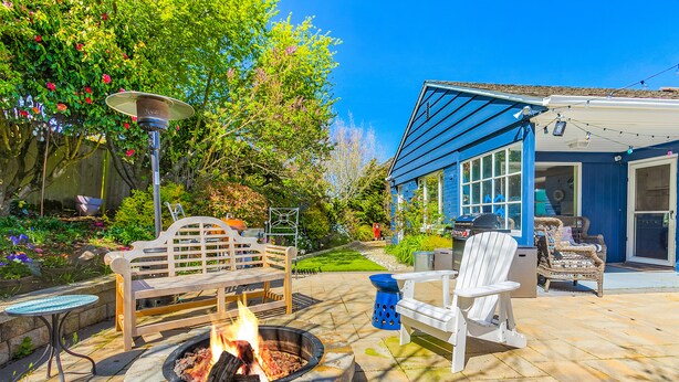A patio with a fire pit, outdoor furniture, and a garden. - Magnolia on the Hill (Seattle)