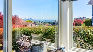 A view from a window with a cityscape in the background, including a prominent skyscraper. - Magnolia on the Hill (Seattle)