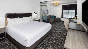 A hotel room with a large bed, a desk, a chair, and a TV. - La Quinta Inn & Suites by Wyndham Austin Parmer/Tech Ridge (Austin)