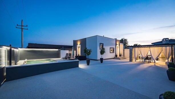A modern outdoor patio area with a hot tub, seating, and potted plants. - Villa Marsel (4+2) - Private Pool and Jacuzzi (Gajana)