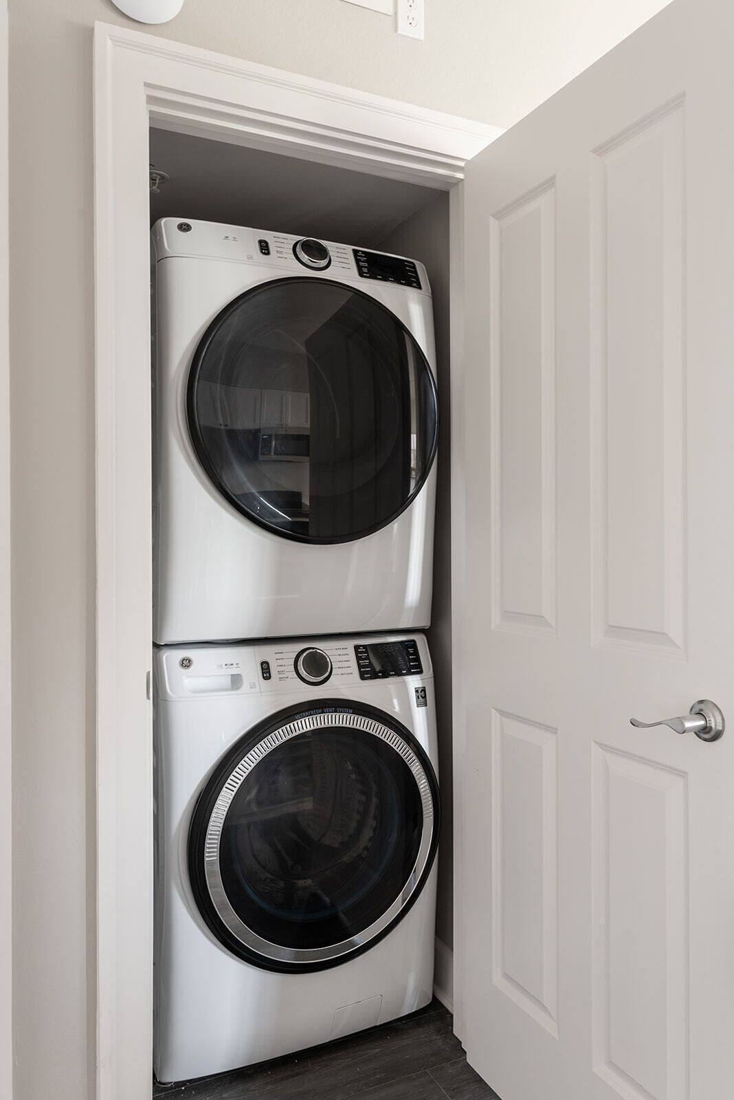 A laundry room with two stacked front-loading washing machines.