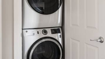 A laundry room with two stacked front-loading washing machines.