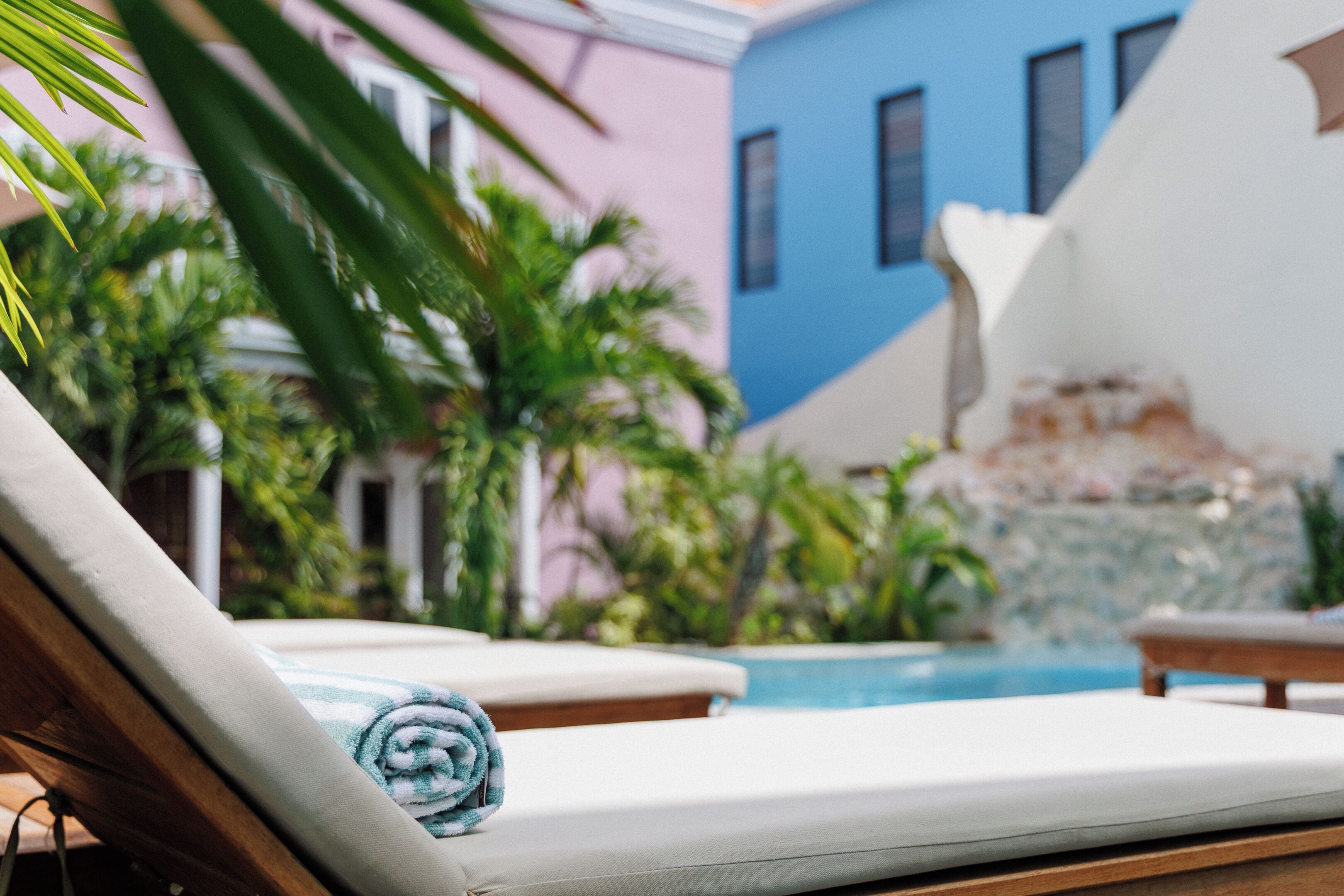 A poolside area with lounge chairs and a towel.