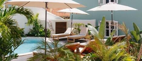 2 outdoor pools, open 8:00 AM to 10:00 PM, pool umbrellas, pool loungers
