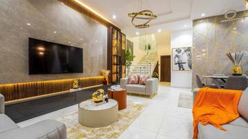 Luxury Duplex | Living room | 65-inch Smart TV with cable channels, TV, Netflix