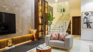 Luxury Duplex | Living room | 65-inch Smart TV with cable channels, TV, Netflix