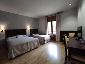A hotel room with two beds, a desk, and a chair. - Snö Bielsa (Bielsa)