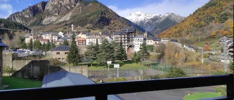 A mountainous town with buildings and a view of snow-capped peaks.