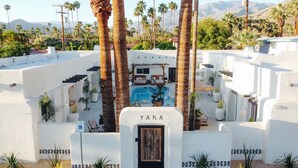 A resort with a pool, palm trees, and a sign reading "YARA". - Yara Hotel (Palm Springs)