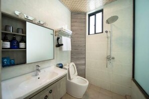 A bathroom with a sink, toilet, and shower.