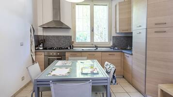 Frigorifero, forno, lavastoviglie, tavolo da pranzo