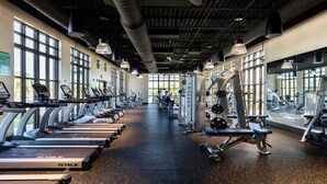 A gym with treadmills, weight machines, and free weights.