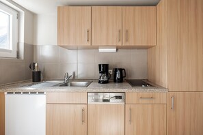 Fridge, stovetop, dishwasher, coffee/tea maker