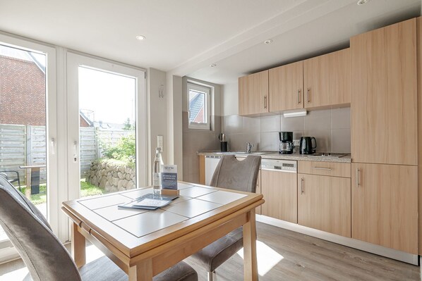 Fridge, stovetop, dishwasher, coffee/tea maker