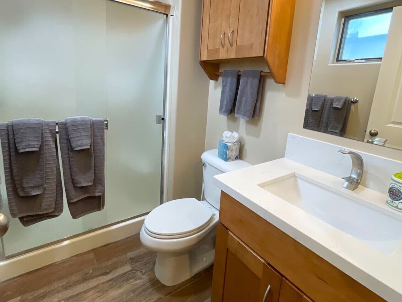 A bathroom with a shower, toilet, and sink.