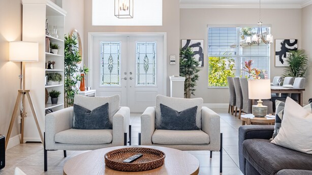 A modern living room with a sofa set, a coffee table, and a bookshelf. - Sauna, Paddle Boards, Gulf Access, Heated Pool - Villa Sun Kissed - Roelens Vacations (Cape Coral)