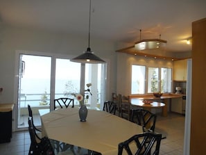Enjoy meals with family and friends in this dining area, featuring a large table and comfortable seating for four.