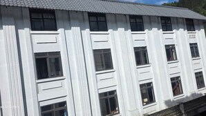 A white building with multiple windows and balconies.