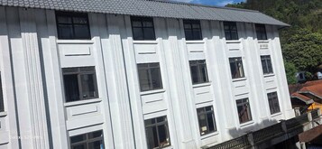 A white building with multiple windows and balconies.