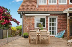 Outdoor dining - Holiday Home "Huus ant Diek" with Private Terrace & Wi-Fi (Norden)