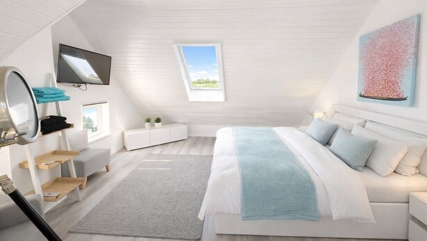 A modern bedroom with a bed, a TV, a window, and a painting.