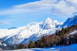 A snow-covered mountain range with clear skies.